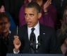 President Barack Obama holds up a pen as he speaks about the economy and the deficit, November 9, 20