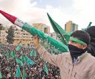 A Palestinian holding a rocket during a Hamas 25 year rally in Hebron, December 14, 2012. 