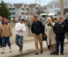 President Barack Obama, center, talks with a local resident