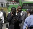 Kenyans talk on their cellular phones in downtown Nairobi