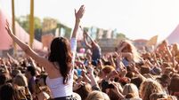 People with their arms in air at music festival