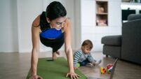 Mother Exercise With Her Baby At Home