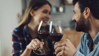 Close up of young couple toasting with red wine