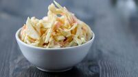 Coleslaw in a bowl on  wooden table