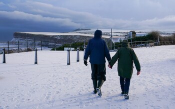 A couple walk in the snow in Saltburn last week