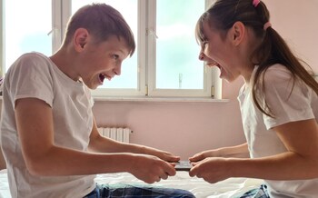 A brother and sister fight over a gadget